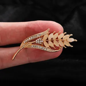 Macro view of elegant wheat stalk brooch with cat's eye stones and sparkling crystals