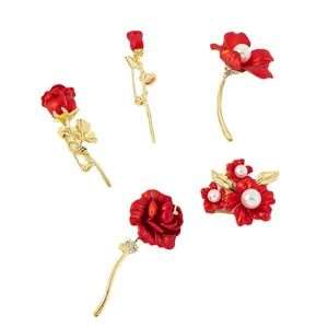 Set of vintage red flower brooches with pearls and gold stems for elegant gifts