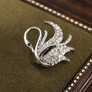 Detailed macro view of an elegant silver swan brooch accented with clear rhinestones