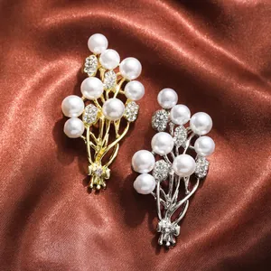 Close-up of elegant pearl bouquet brooches with sparkling rhinestone accents