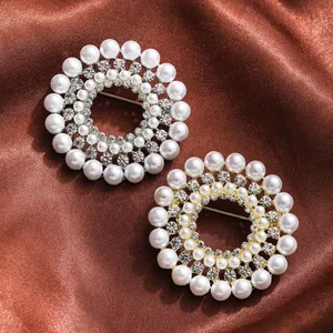 Close-up detail of elegant circular pearl brooches with sparkling rhinestone accents