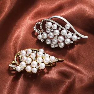 Close-up view of gold and silver pearl brooches with shimmering rhinestones