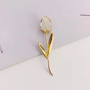 Close-up of elegant tulip brooch with cat's eye stone and sparkling rhinestones