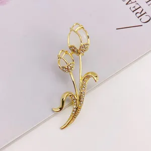 Elegant gold-tone tulip brooch with cat's eye stone and crystal inlay details