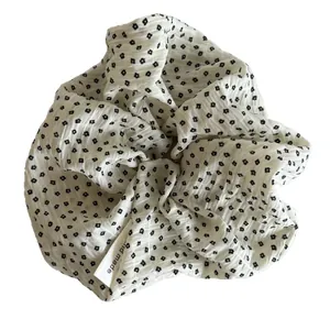Elegant Korean style white fabric scrunchie with delicate black floral pattern and handmade tag