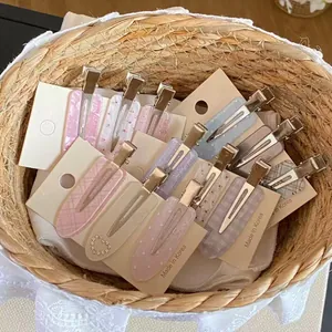 Detailed view of assorted heart and plaid patterned hair clips in a woven basket
