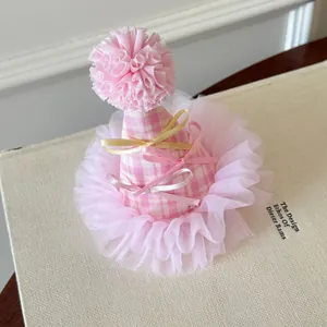 Detailed macro view of a pink gingham party hat hair clip featuring cute bows and tulle lace