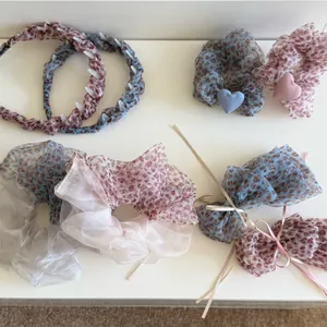 Detailed view of leopard print mesh hair accessories including scrunchies and headbands.