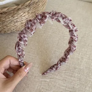 Detailed view of a stylish leopard print mesh headband featuring soft pleated design