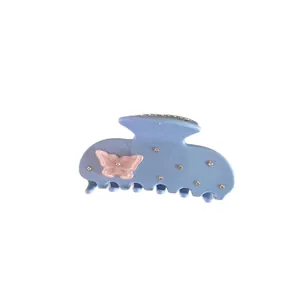 Elegant blue acetate hair claw clip with a pink butterfly and tiny rhinestones