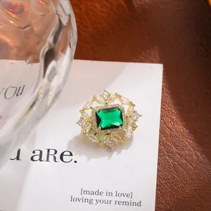 Primer plano de un lujoso broche de cristal verde esmeralda con oro