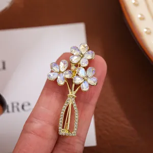 Detailed view of an elegant vintage crystal flower vase brooch with iridescent petals