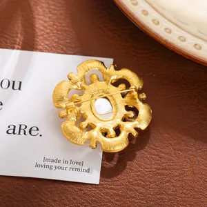 Vue détaillée de l'arrière d'une broche baroque vintage dorée avec épingle de sûreté