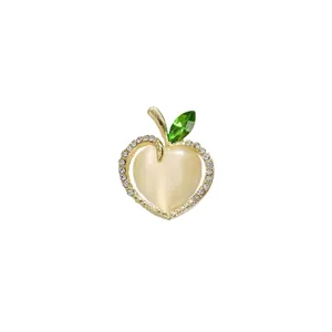 Elegant gold-toned apple brooch with sparkling rhinestones and green leaf detail
