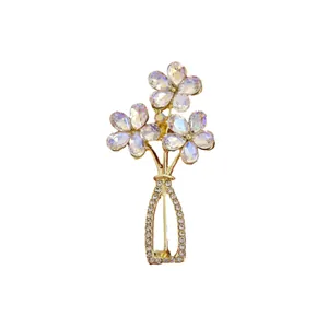 Elegant crystal flower vase brooch with iridescent petals and premium gold finish.