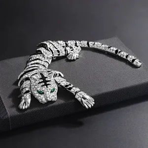 Detailed view of heavy-duty crystal tiger brooch with green eyes and enamel stripes