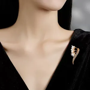 Luxurious Lily of the Valley brooch with sparkling crystals on black dress worn by model