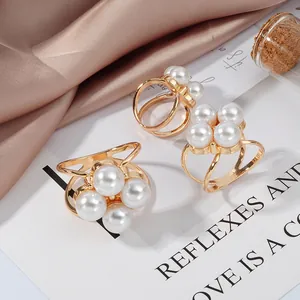Elegant gold alloy scarf clip featuring four round faux pearls and hollow ring design.