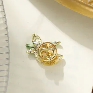 Detailed close-up showing the butterfly clutch on a golden watermelon fruit lapel pin