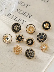 Collection of vintage gold-toned lapel pins with black enamel designs and nautical motifs