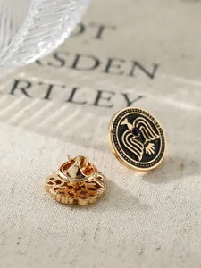 Detailed macro shot of vintage gold lapel pin with black enamel and eagle emblem