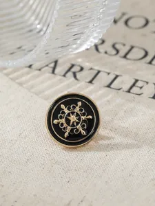 Macro view of vintage gold and black enamel lapel pin with a nautical star motif