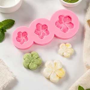 Dettaglio dello stampo in silicone rosa a cinque petali e fiori in pasta di zucchero