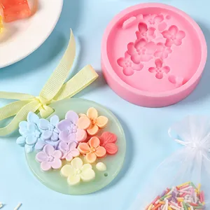 Embossed cherry blossom silicone mold with finished pastel floral wax tablet and ribbon