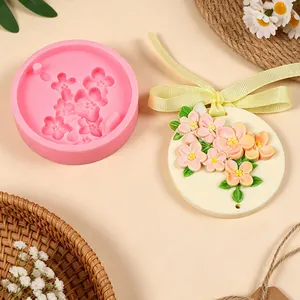 Close-up view of relief cherry blossom silicone mold with finished floral wax tablet