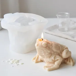 Detail view of a lucky toad silicone mold with a finished handmade scented candle.