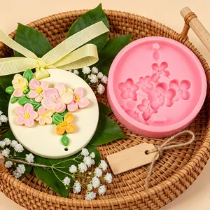 Detailed view showing a cherry blossom silicone mold alongside a finished aroma plaque
