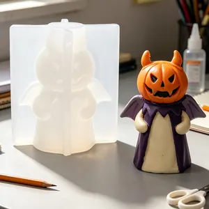 DIY Halloween pumpkin ghost silicone mold with finished candle ornament on a creative craft desk