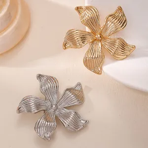 Detaillierte Makroansicht von gold- und silbernen Blumenbroschen mit eleganter Textur