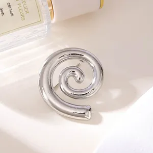 Nahaufnahme einer silberfarbenen Spirale-Brosche aus Legierung mit Glanzfinish.