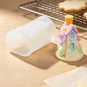 Close-up detail of translucent silicone house mold with colorful resin figurine