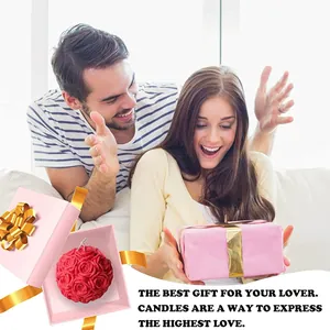 Lifestyle-Szene zeigt eine rote Rosenkerze in einer rosa Geschenkbox als Überraschungsgeschenk.