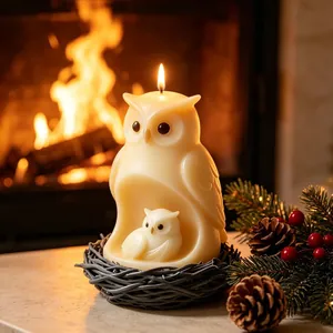 Detailed view of handcrafted owl-shaped candle nestled in a cozy fireplace setting