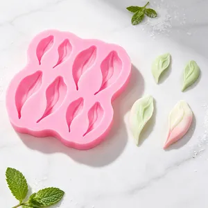 Close-up view of pink flower petal silicone mold with fondant leaf samples