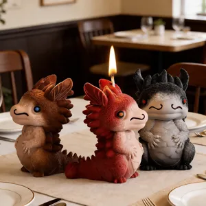 Close-up of three cute dragon candles in a warm restaurant setting