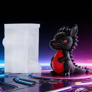 Detailed view showing white silicone dragon mold beside finished black and red resin dragon ornament