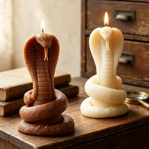 Detailed macro view of two cobra-shaped scented candles on a vintage wooden desk