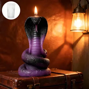 Detailed view of cobra snake silicone mold with finished purple scented candle on suitcase