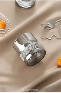 Close-up of a luxurious whisky glass with a sparkling rhinestone decorative band.