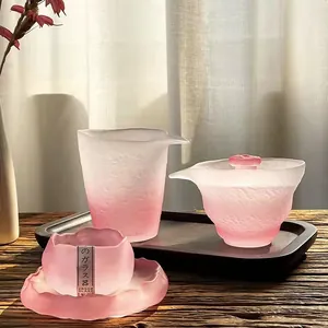 Macro detail of pink frosted glass tea set with elegant gradient texture in natural light.