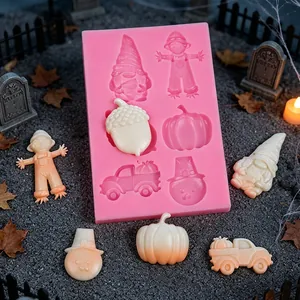 Detailed macro view of a pink silicone mold featuring gnome, pumpkin and scarecrow shapes.