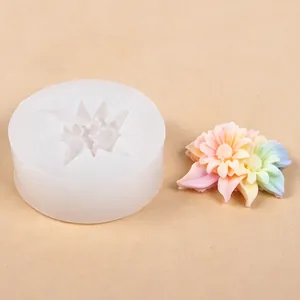 Detailed view of a sunflower silicone mold alongside a colorful resin flower sample