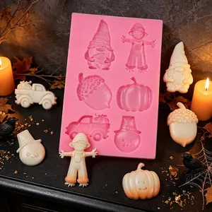 Close-up of 6-cavity autumn theme silicone mold with finished gnome and pumpkin shapes