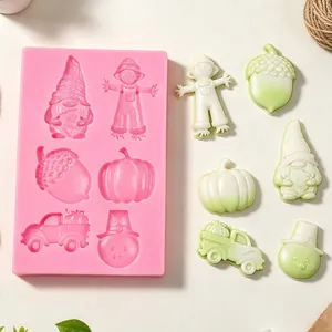 Close-up detail showing autumn silicone mold with finished gnome and pumpkin shapes