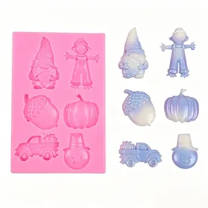 Pink silicone mold featuring gnome, pumpkin and acorn shapes for DIY resin or baking
