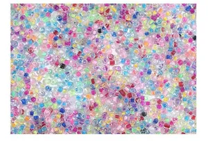 Detailed macro shot of mixed colorful glass seed beads for DIY jewelry crafting.